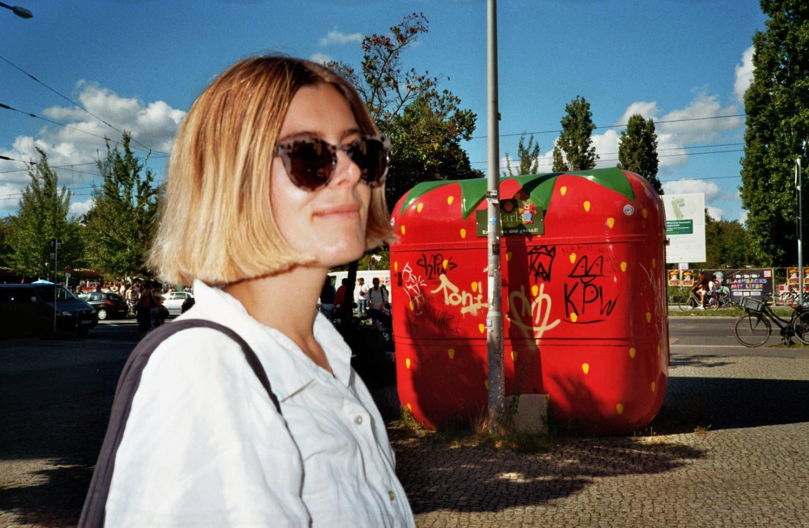 Nicole in Berlin, in front of a giant strawberry