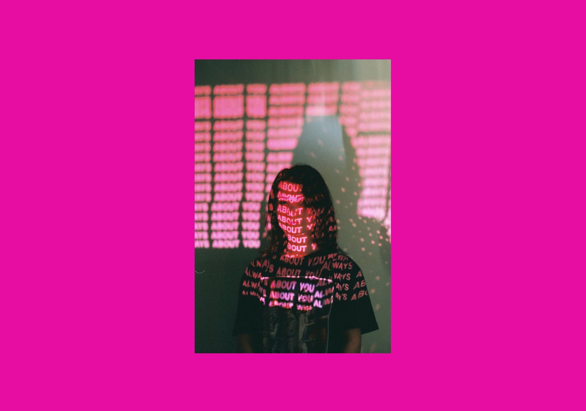 Projected typography portrait on magenta